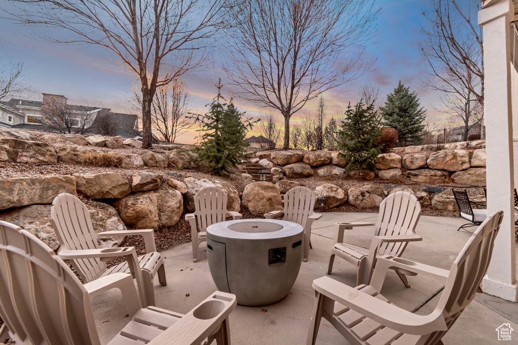 View of patio with an outdoor fire pit