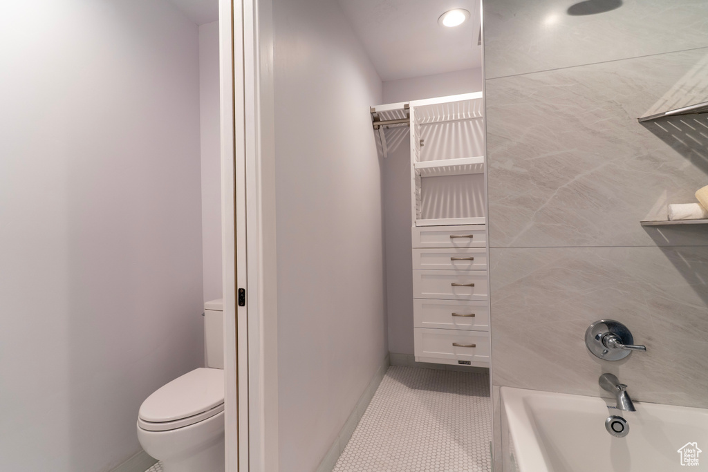 Full bathroom featuring toilet, tile patterned floors, and baseboards