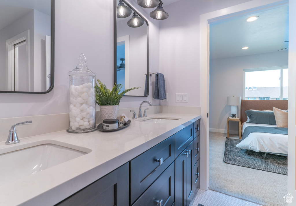 Ensuite bathroom with recessed lighting, ensuite bath, a sink, and double vanity