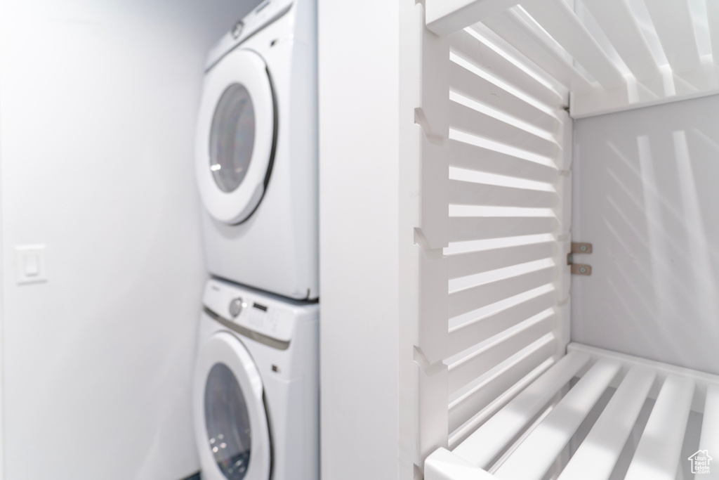 Clothes washing area with stacked washer / dryer and laundry area