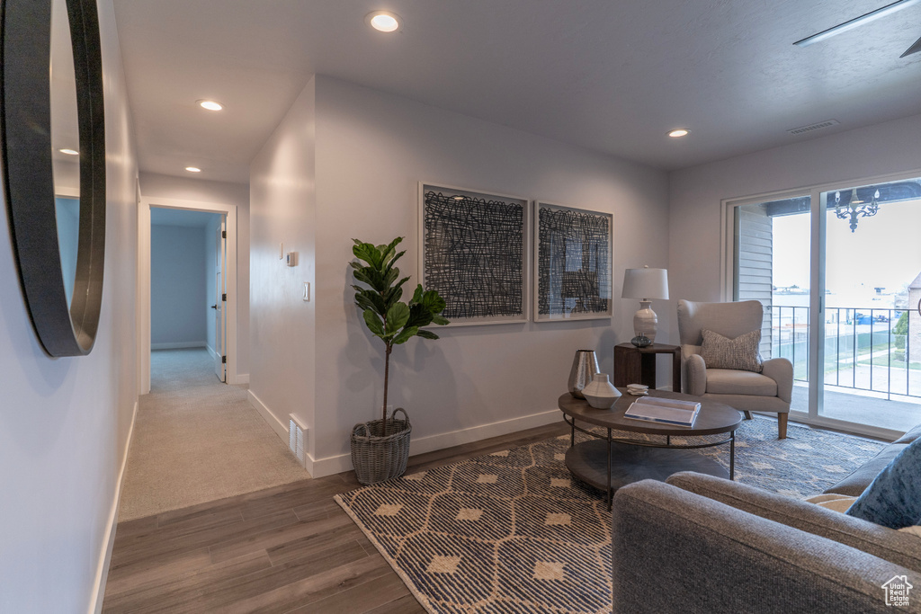 Living area with baseboards, visible vents, wood finished floors, and recessed lighting