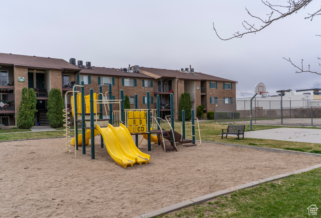 Community play area featuring community basketball court and fence
