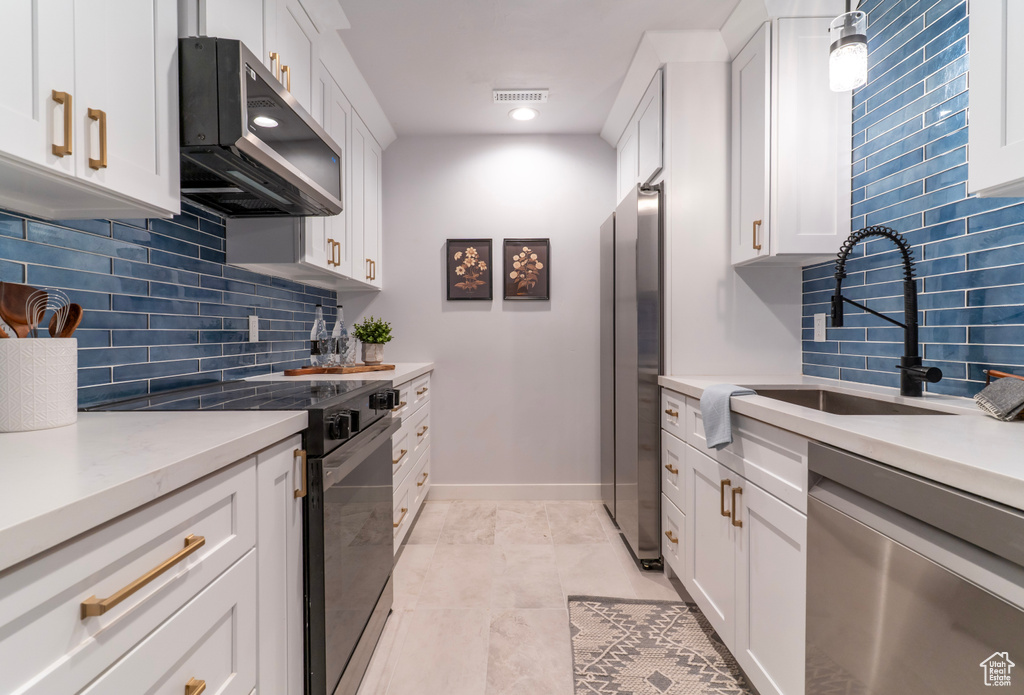 Kitchen with visible vents, white cabinetry, a sink, and appliances with stainless steel finishes