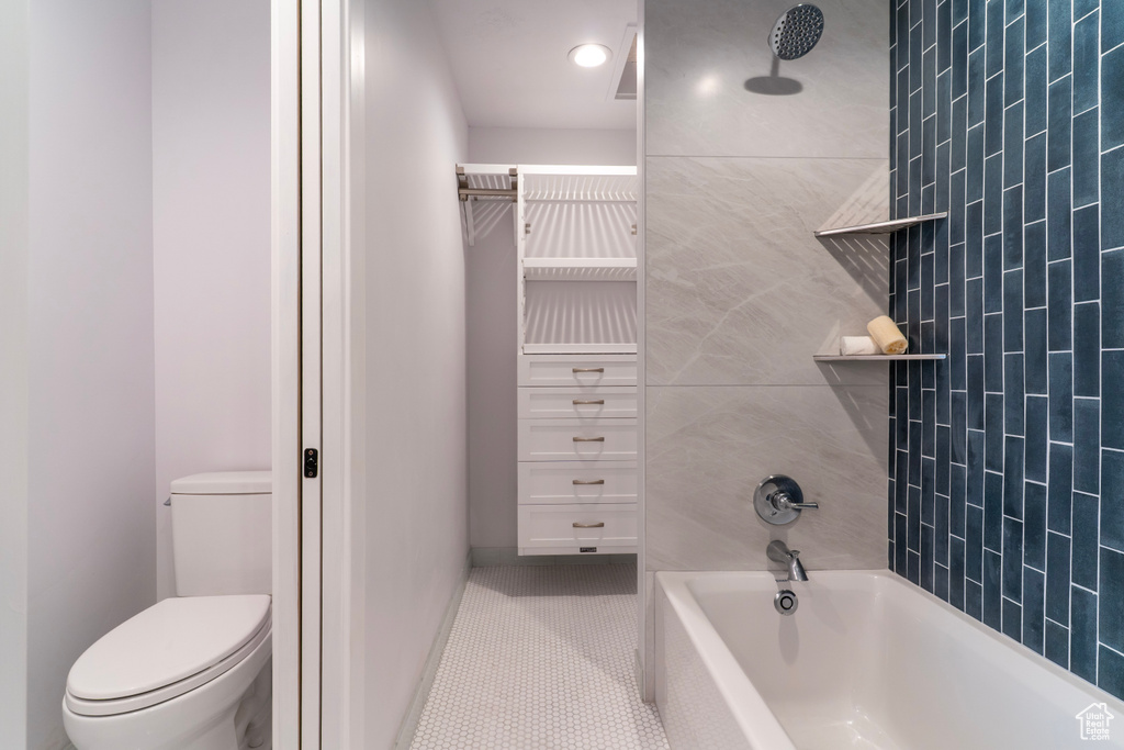 Full bathroom featuring toilet, tile patterned flooring, and shower / bath combination
