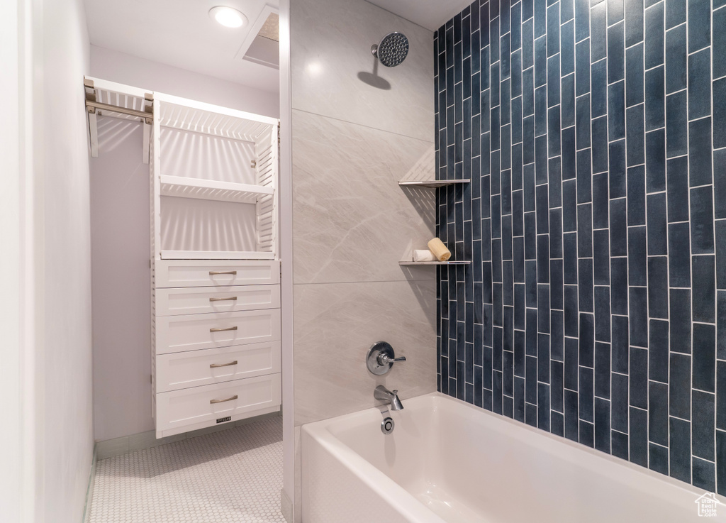 Full bath featuring tile patterned floors and shower / bath combination