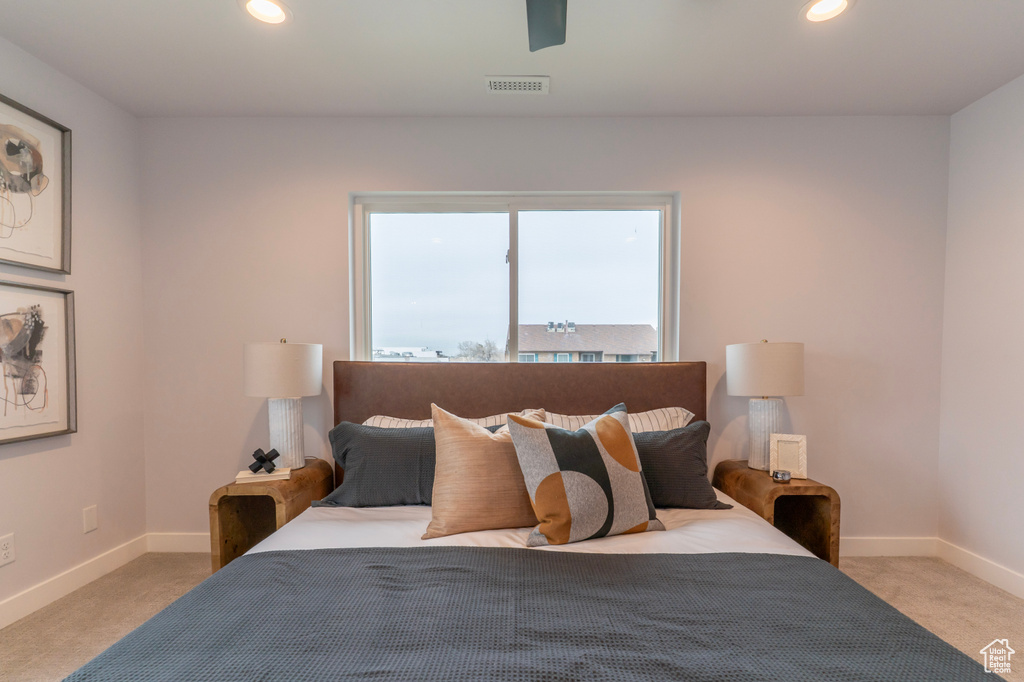 Carpeted bedroom with baseboards, visible vents, and recessed lighting