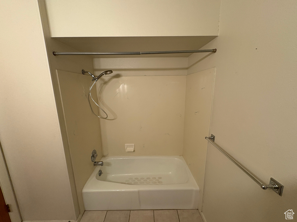 Full bath featuring tile patterned floors and  shower combination