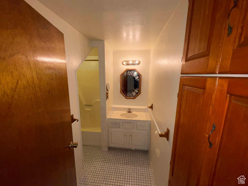 Full bathroom with tile patterned floors and vanity