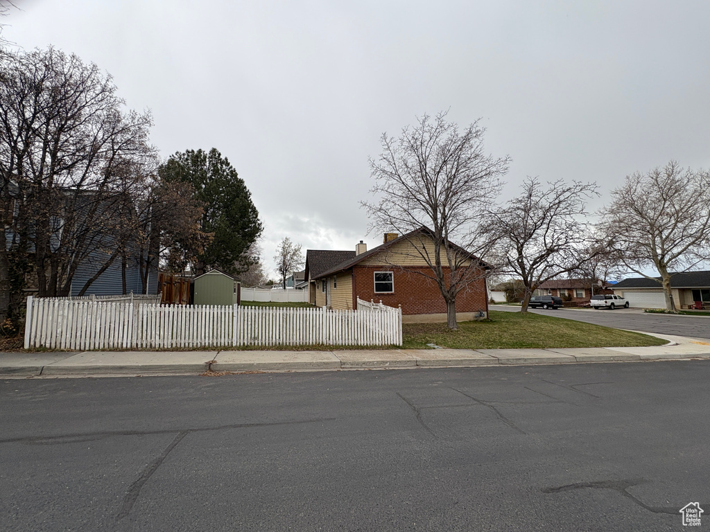 View of front of property with a fenced front yard and a chimney