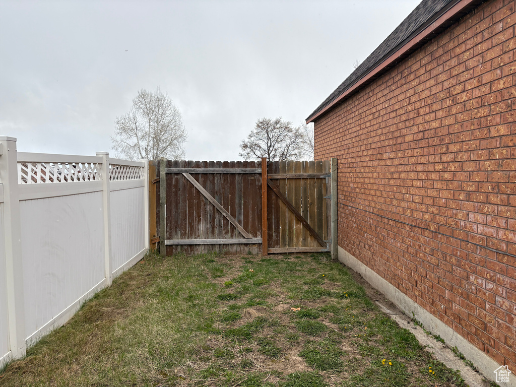 View of yard featuring a gate and fence