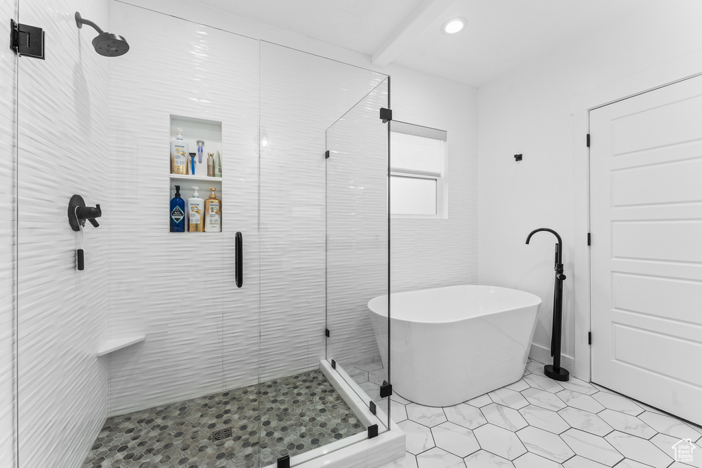 Bathroom featuring a shower stall and a freestanding bath
