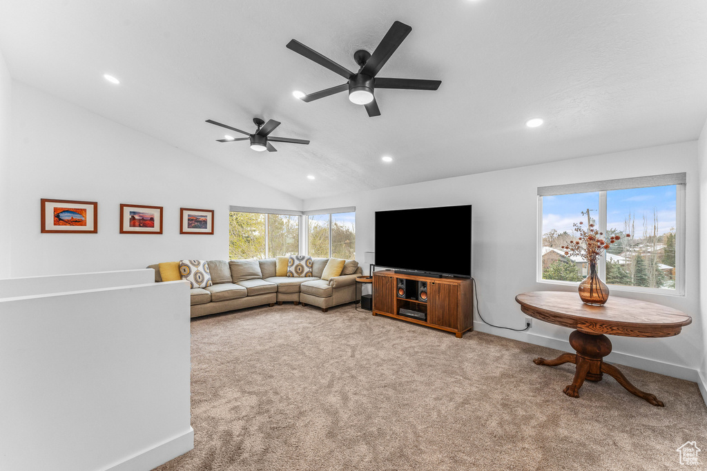 Living area with vaulted ceiling, recessed lighting, carpet flooring, baseboards, and a ceiling fan