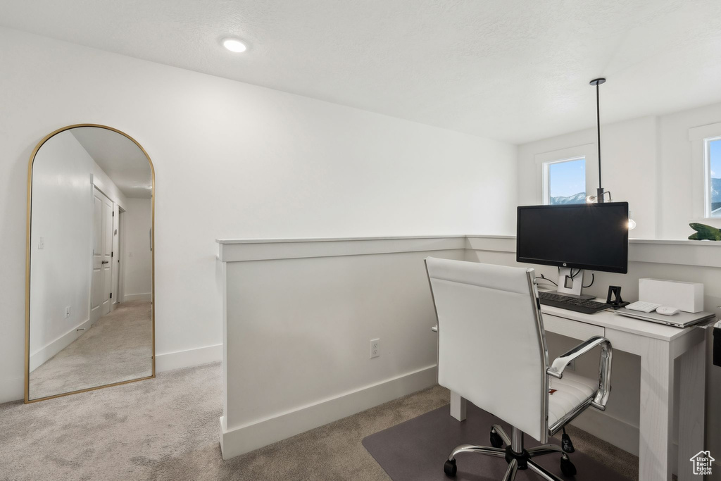 Home office featuring baseboards and light colored carpet