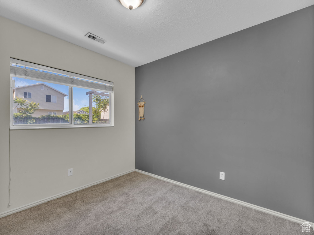 Unfurnished room featuring carpet floors and baseboards