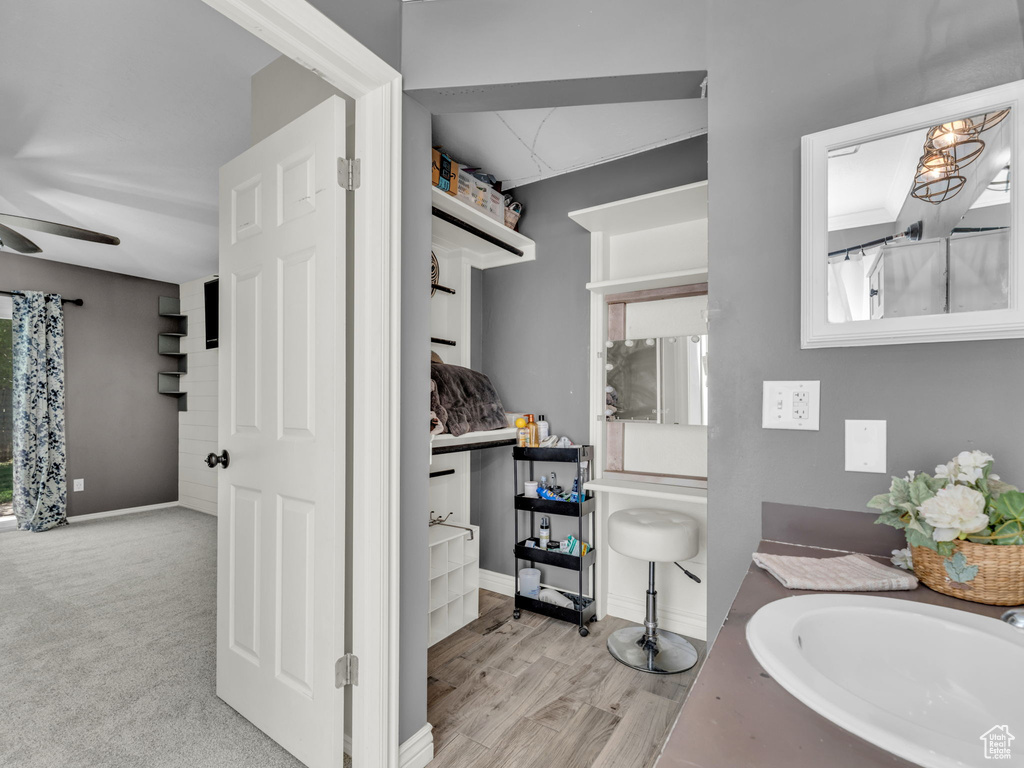 Bathroom featuring a ceiling fan, vanity, and baseboards