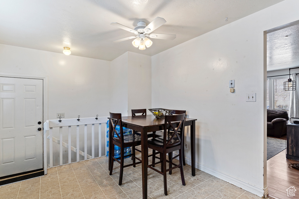 Dining room featuring baseboards and a ceiling fan