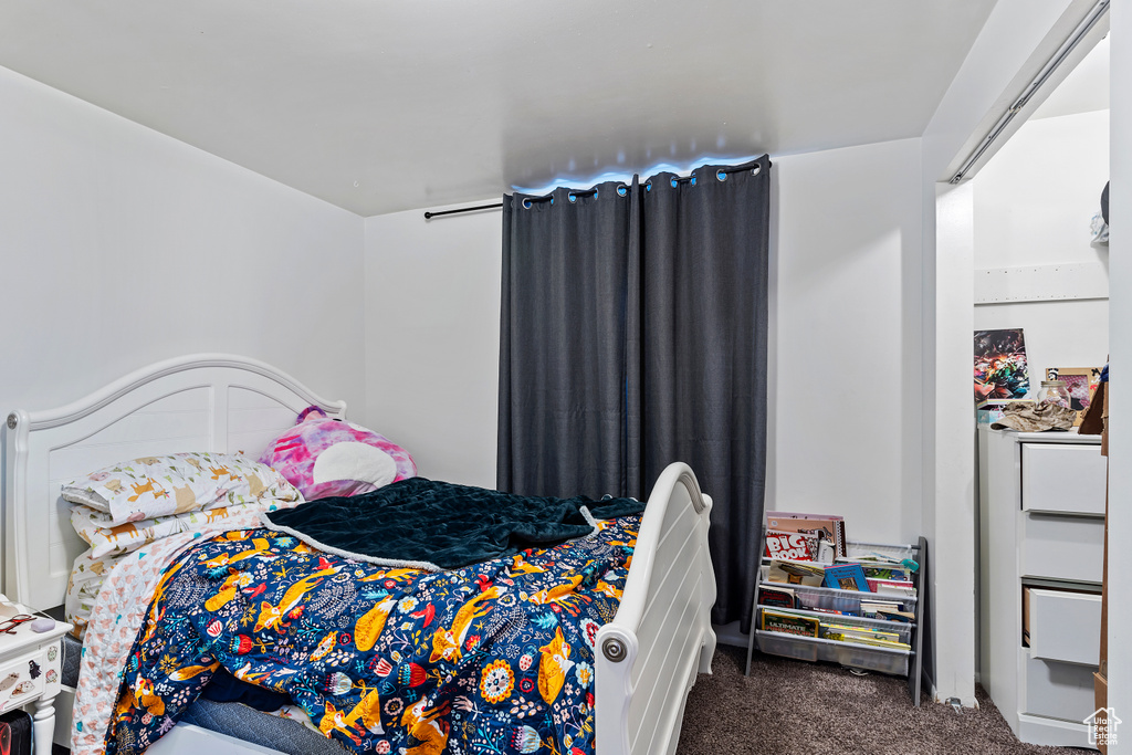 Bedroom with dark colored carpet