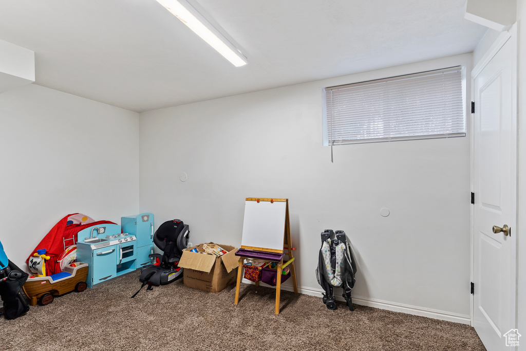 Rec room featuring carpet floors and baseboards