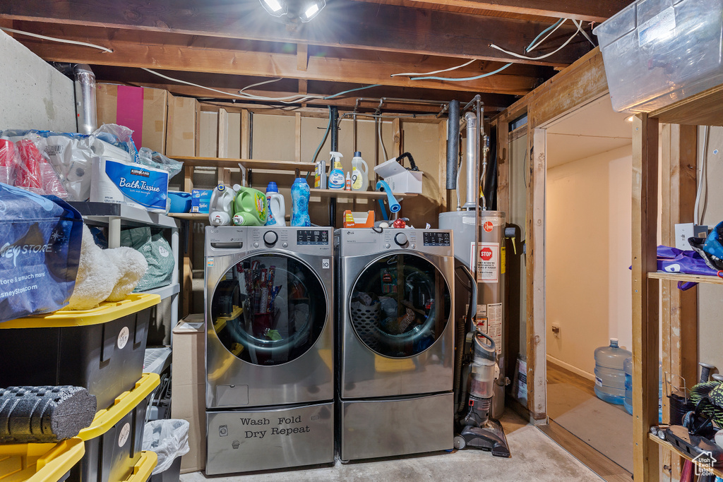 Clothes washing area with water heater, laundry area, and washer and dryer