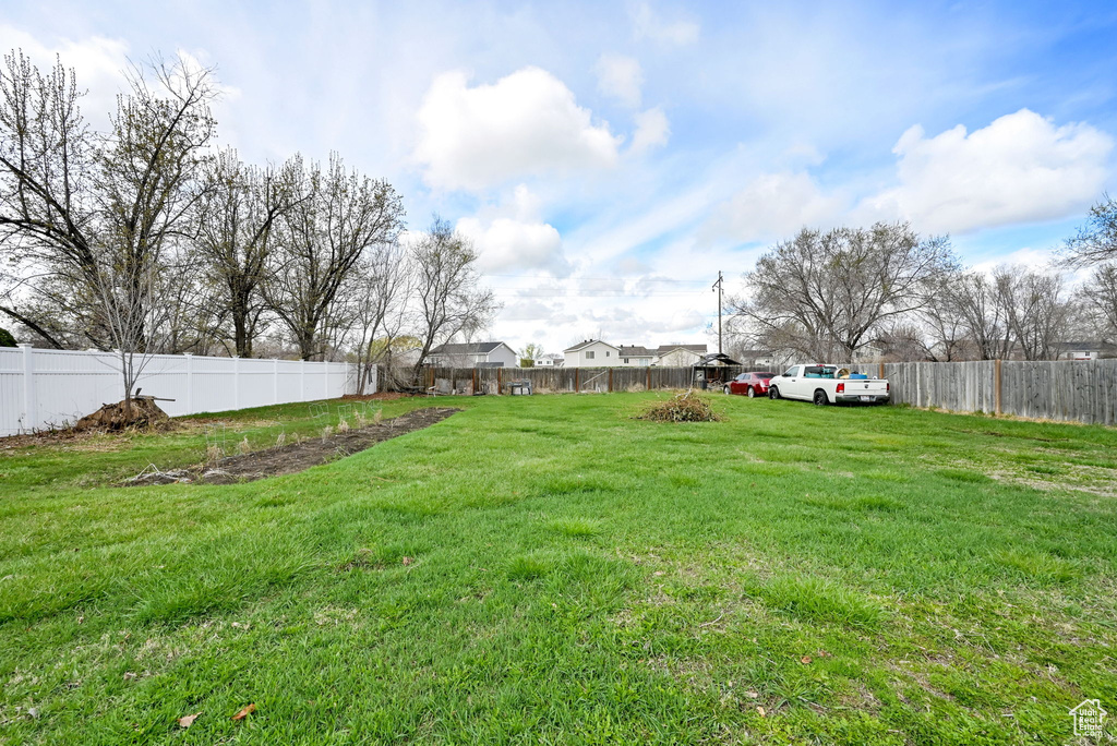 View of yard with a fenced backyard