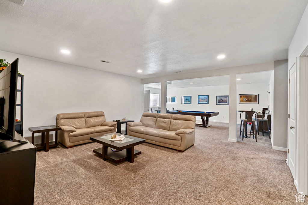 Carpeted living room featuring baseboards, recessed lighting, and billiards