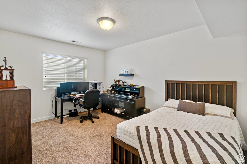 Bedroom featuring baseboards, carpet floors, and visible vents