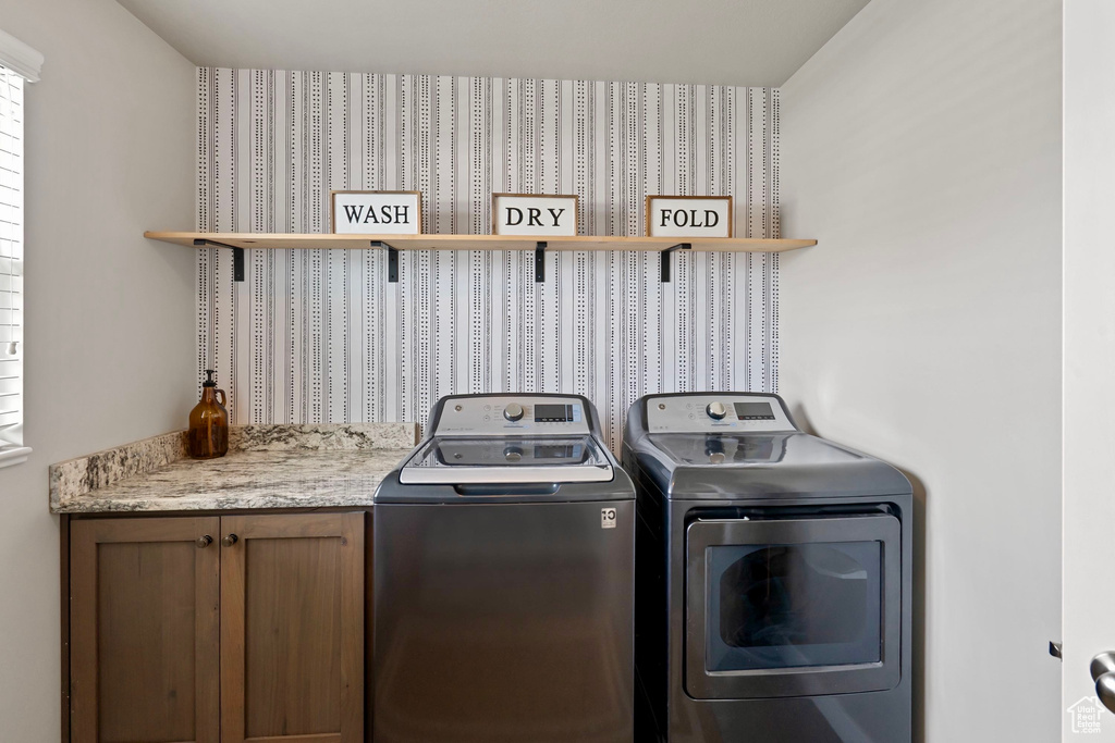 Laundry area with cabinet space and washer and dryer