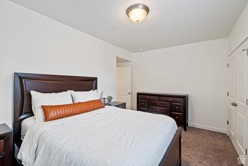 Bedroom with baseboards and carpet floors
