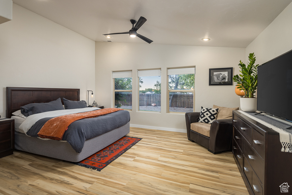 Bedroom with vaulted ceiling, light wood-type flooring, baseboards, ceiling fan, and recessed lighting