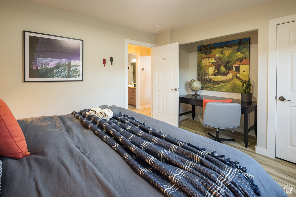 Bedroom with baseboards and wood finished floors