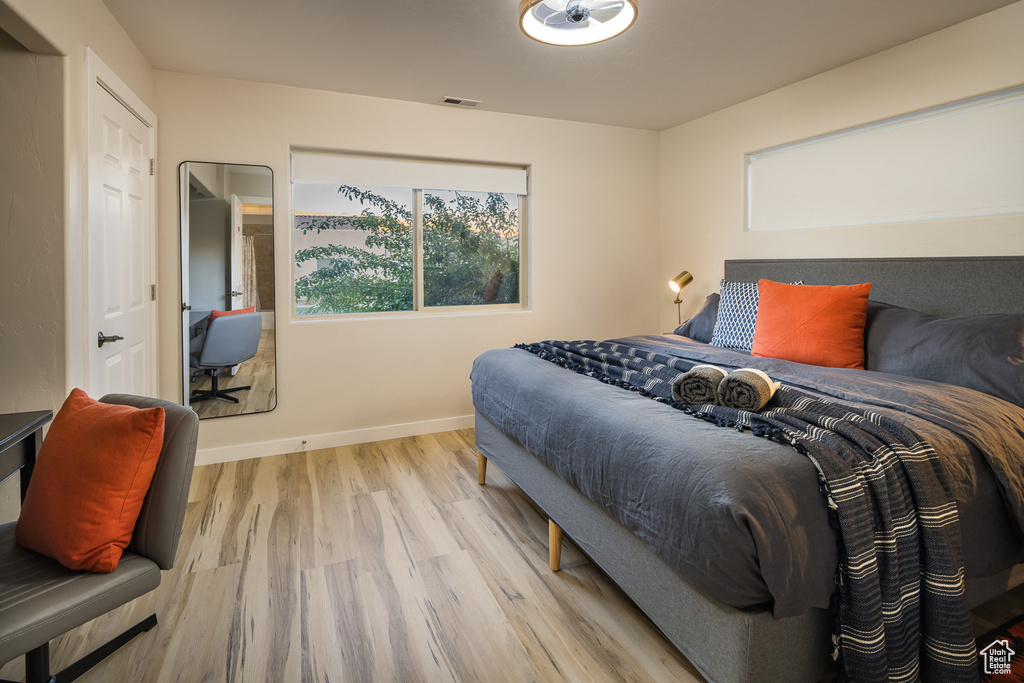 Bedroom featuring baseboards, visible vents, and light wood-type flooring