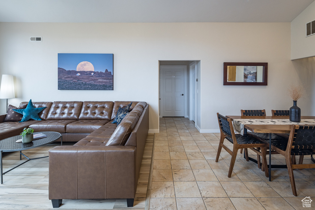 Living area with baseboards and visible vents