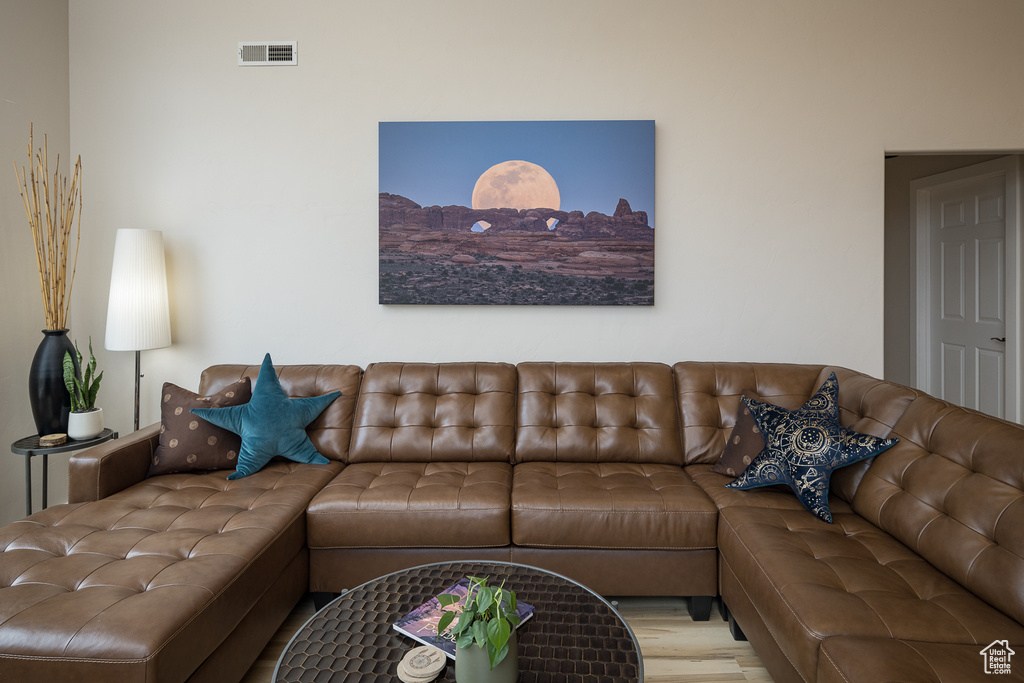 Living room with visible vents and wood finished floors