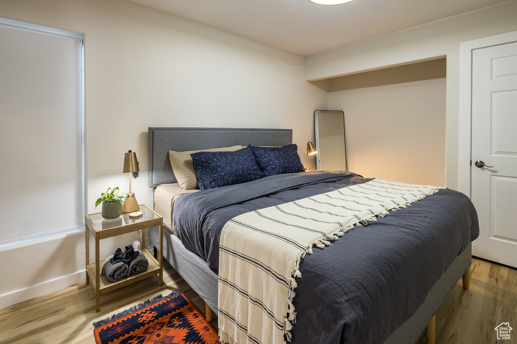 Bedroom with baseboards and wood finished floors