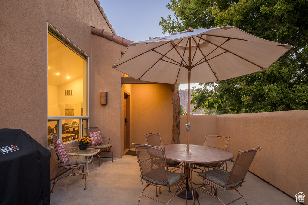 View of patio / terrace with outdoor dining area, visible vents, and grilling area