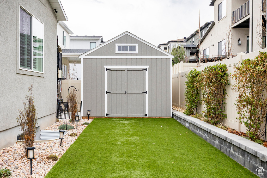 View of shed featuring a fenced backyard