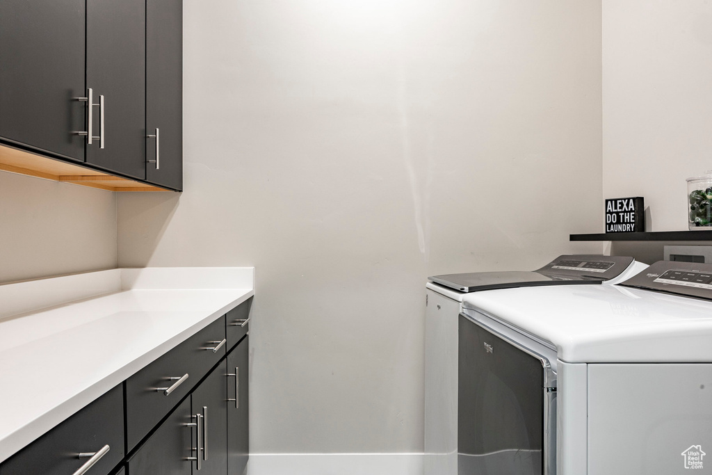 Clothes washing area with cabinet space and washer and clothes dryer