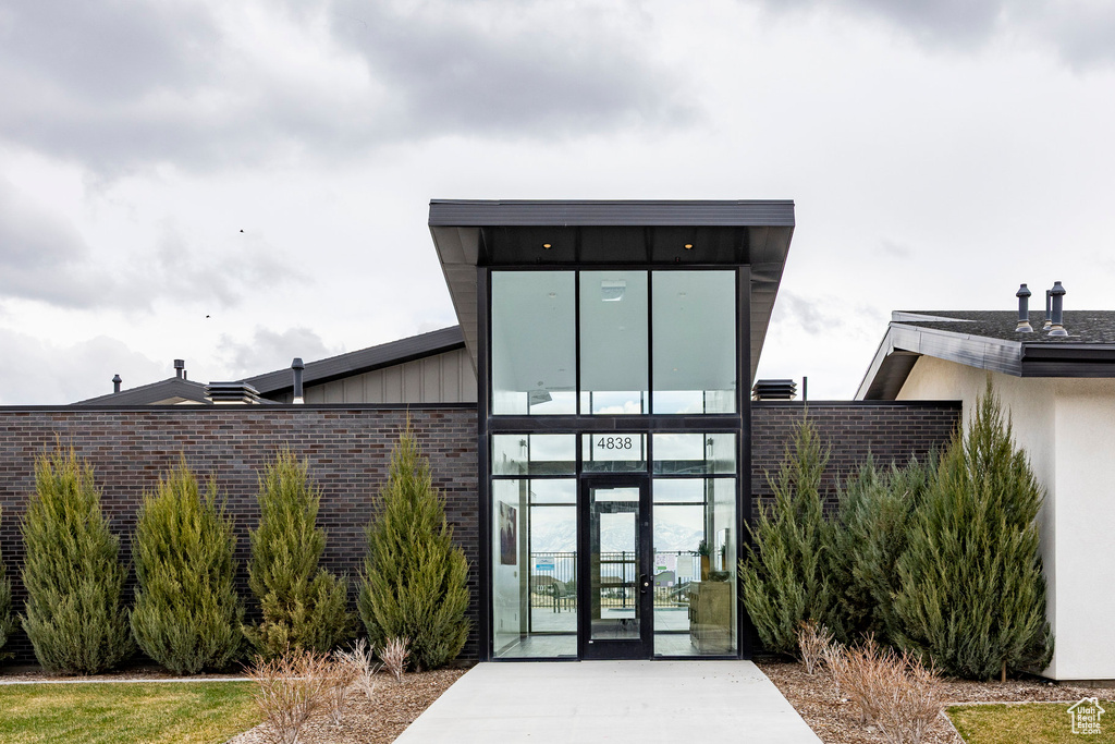 View of exterior entry with brick siding