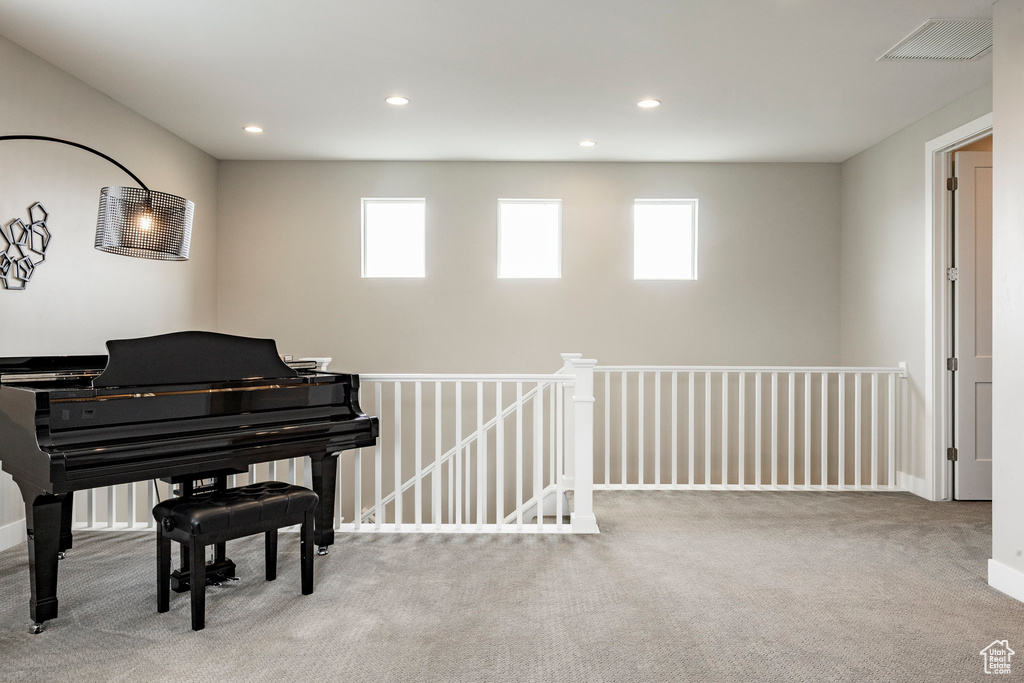 Living area featuring visible vents, carpet, and plenty of natural light