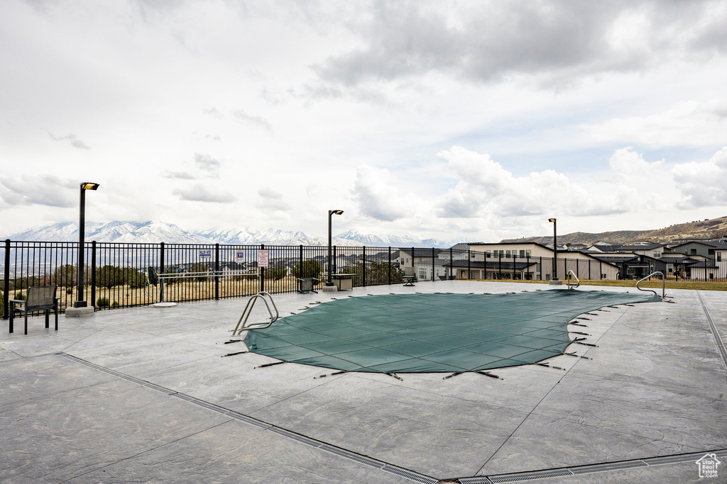 Pool featuring a patio and fence