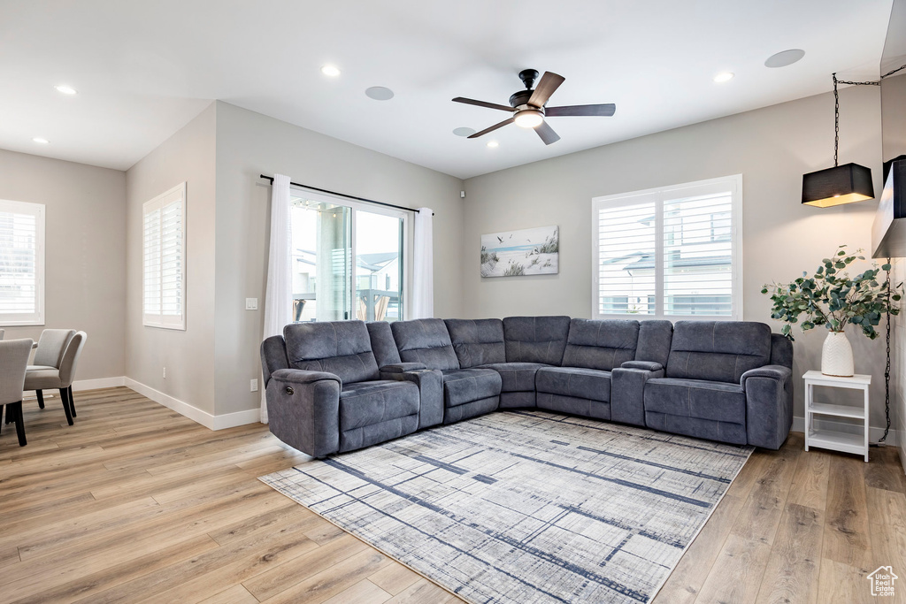 Living room with light wood-type flooring and a wealth of natural light