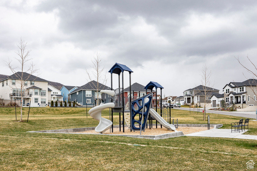 Community playground featuring a residential view and a yard