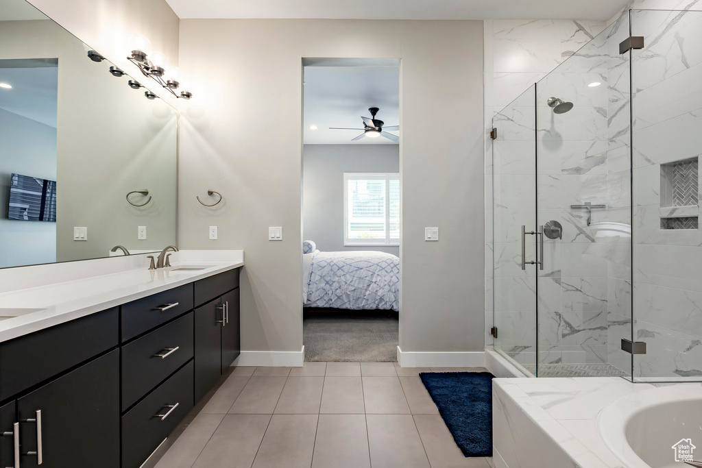 Ensuite bathroom featuring double vanity, baseboards, connected bathroom, a ceiling fan, and a marble finish shower