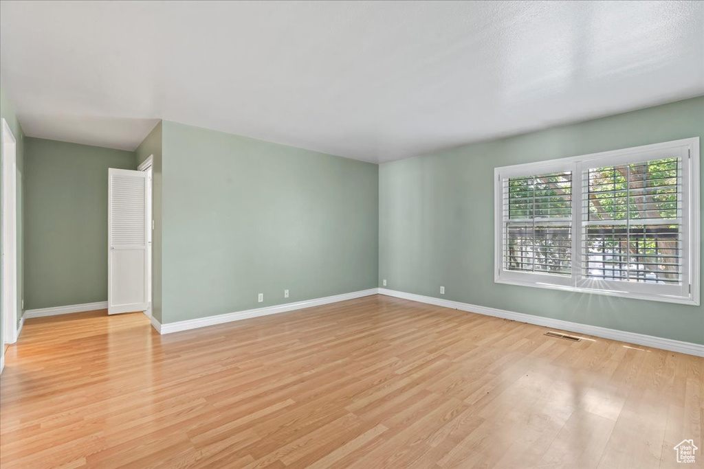 Empty room featuring light wood-type flooring and baseboards