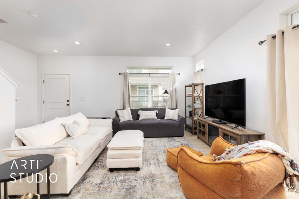 Living room with wood finished floors and recessed lighting