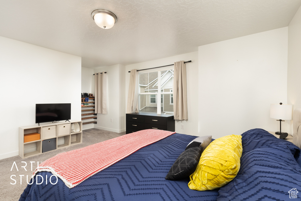 Bedroom with baseboards and carpet