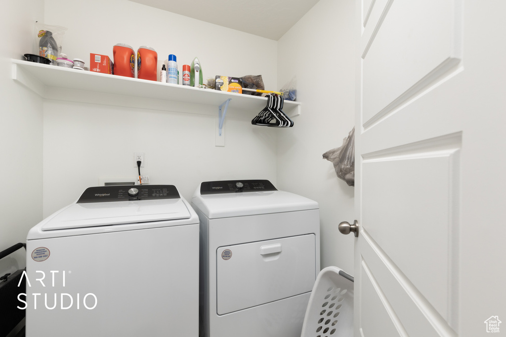Laundry room featuring laundry area and washer and clothes dryer