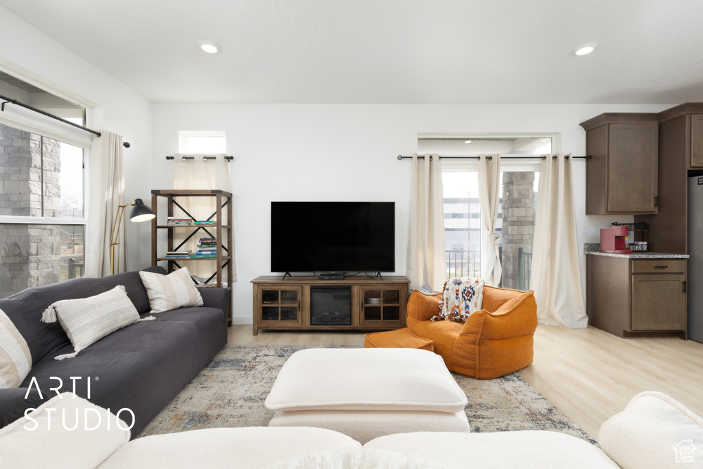 Living room featuring light wood finished floors and recessed lighting