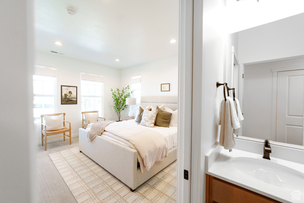 Bedroom with visible vents, a sink, and recessed lighting