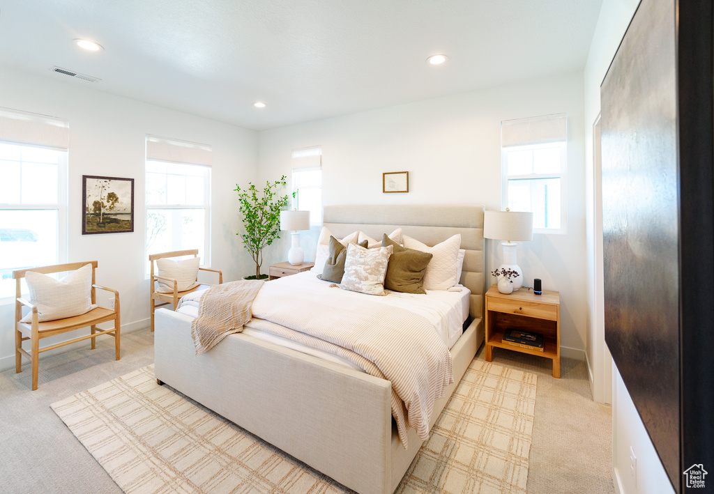 Bedroom with visible vents, multiple windows, and recessed lighting